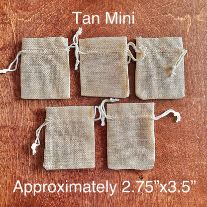 Five tan mini drawstring burlap bags on a wooden surface with text indicating size and color.