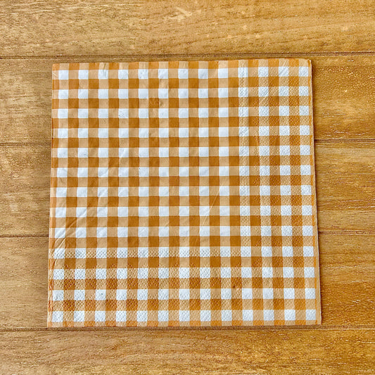 Checkered napkin with brown and white pattern on a wooden surface