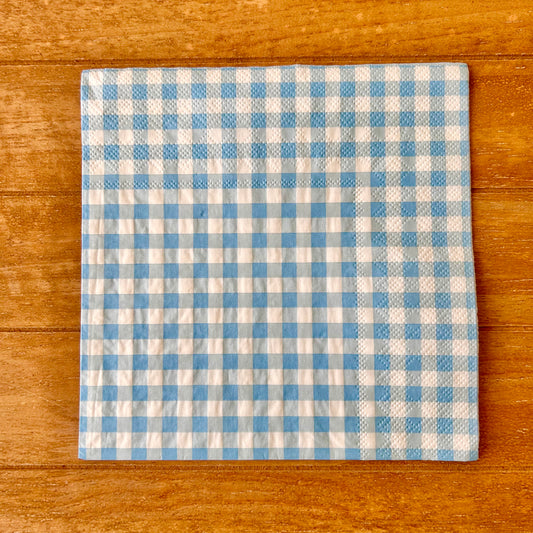 Blue and white checkered napkin on a wooden surface