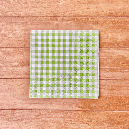 Green and white checkered gingham on a wooden surface