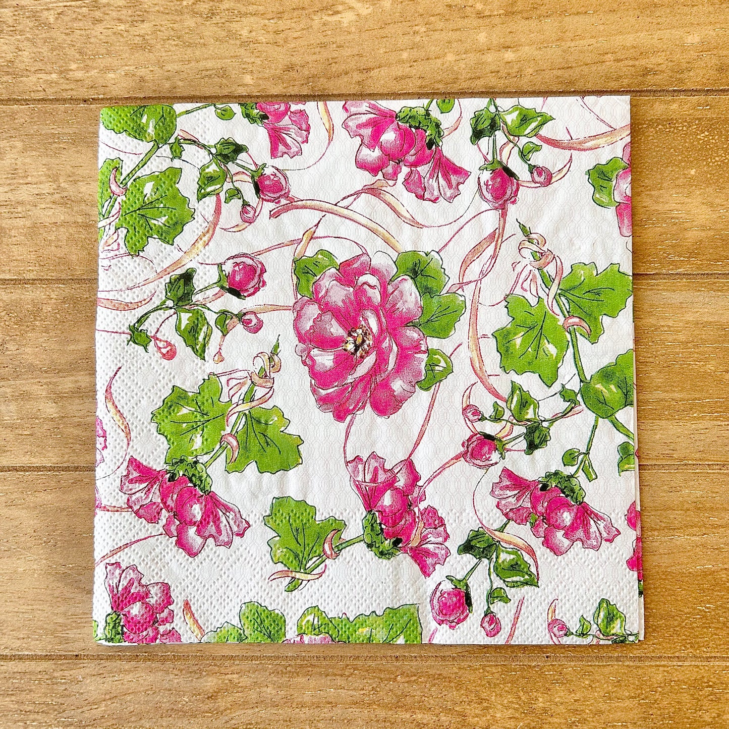 Floral patterned paper napkin on a wooden surface