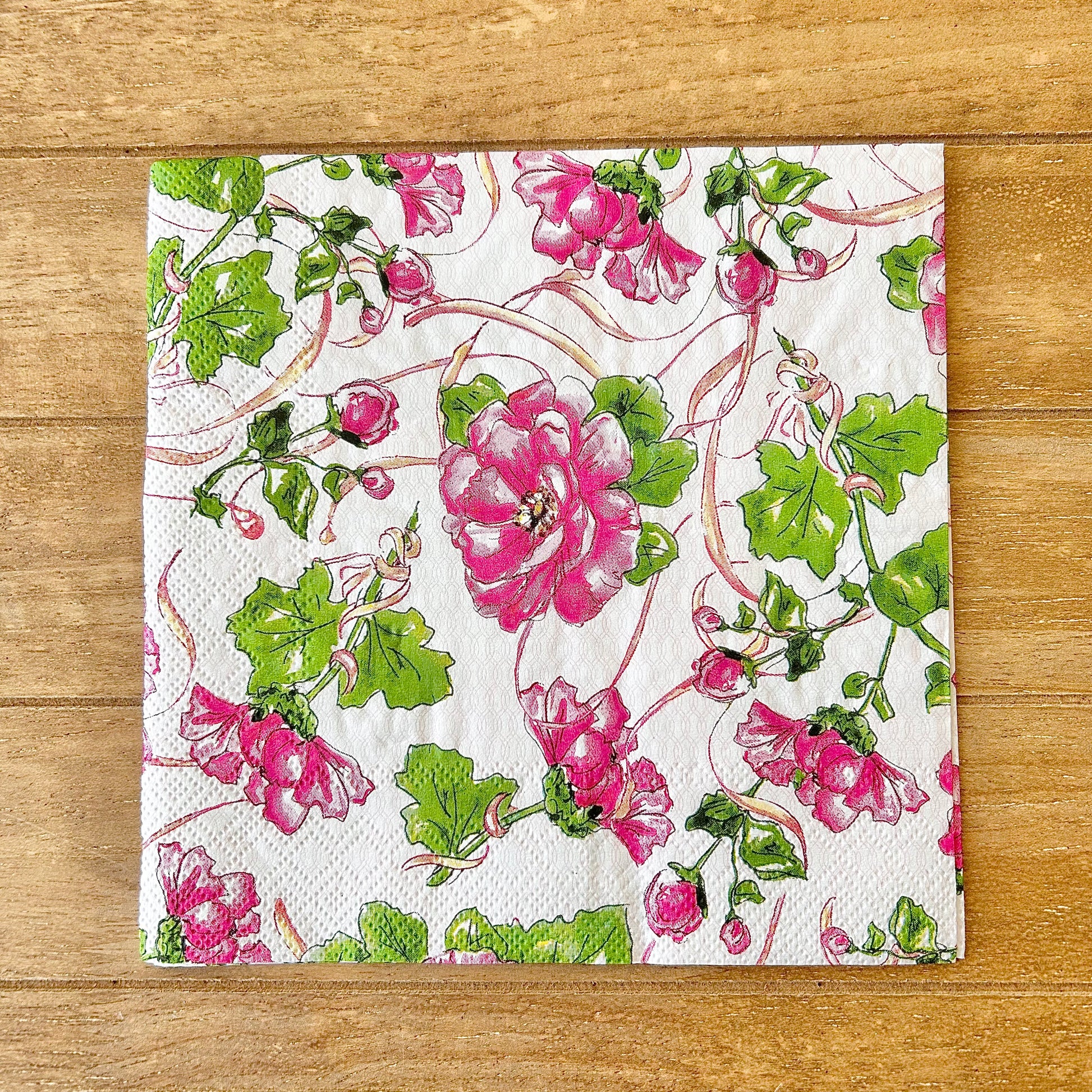 Floral patterned paper napkin on a wooden surface
