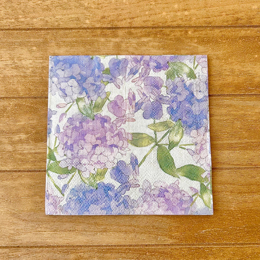 Floral purple patterned paper napkin on a wooden surface