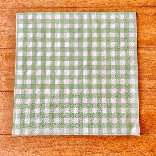 Green and white checkered napkin on a wooden surface