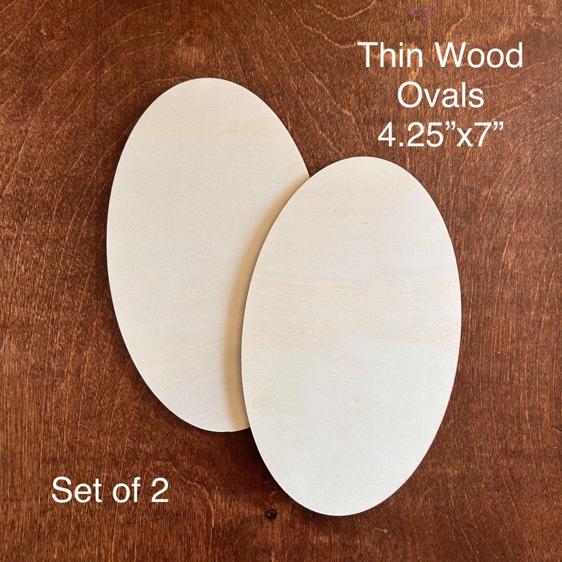 Two thin wood ovals on a wooden surface with dimensions and quantity text.