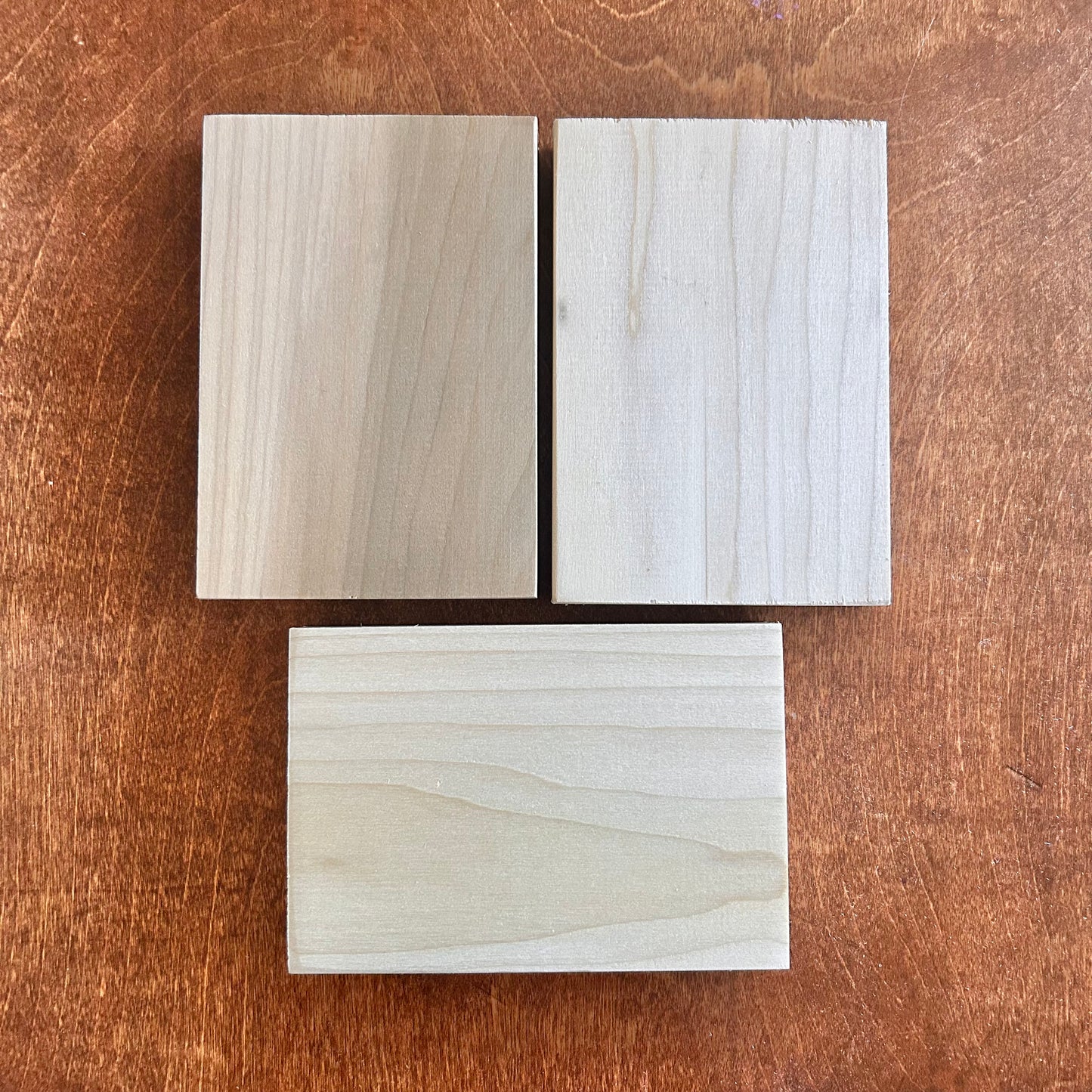 Three wooden samples on a wooden surface
